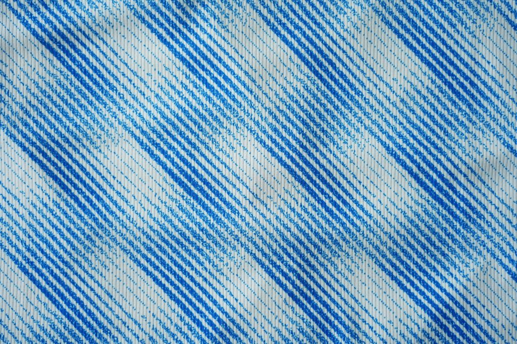 Close up of blue football jersey sports clothing fabric texture.