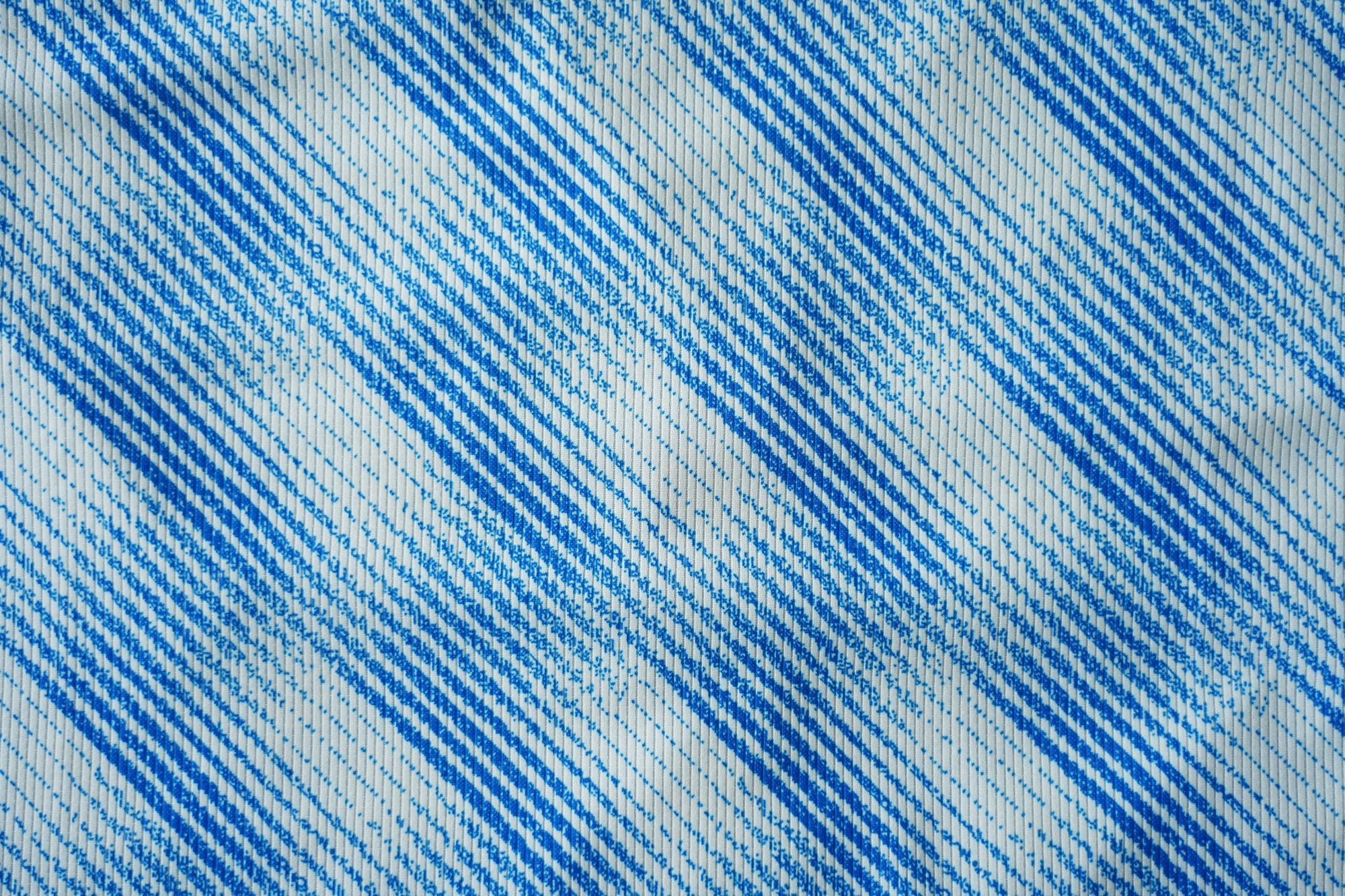 Close up of blue football jersey sports clothing fabric texture.