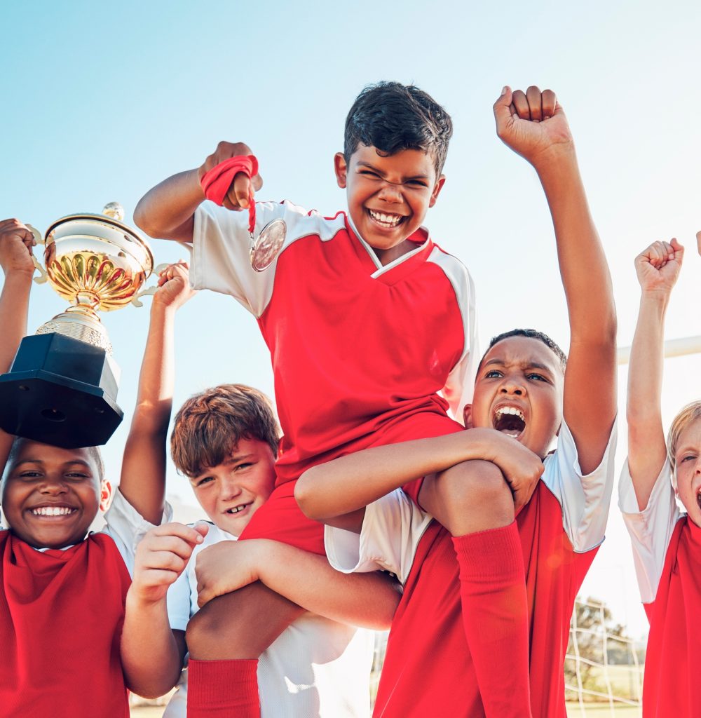 Soccer, celebration and kids team with trophy on soccer field, happy and excited at winning game. S